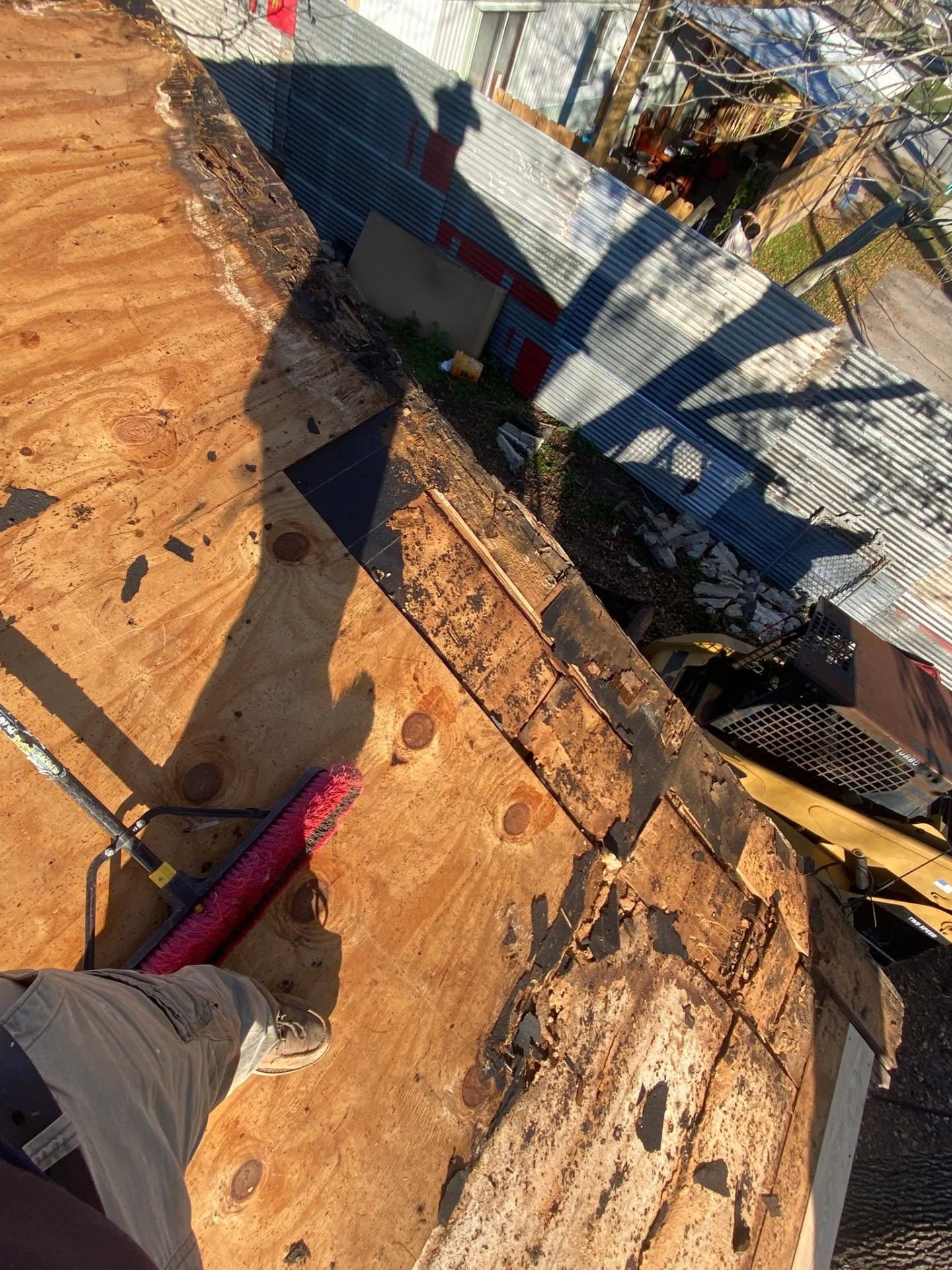 Fresh plywood decking installed during a full roof replacement
