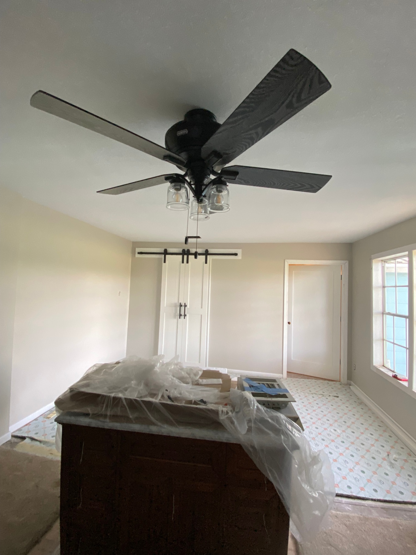 Bedroom remodel with new ceiling fan, sliding closet doors, and updated finishes
