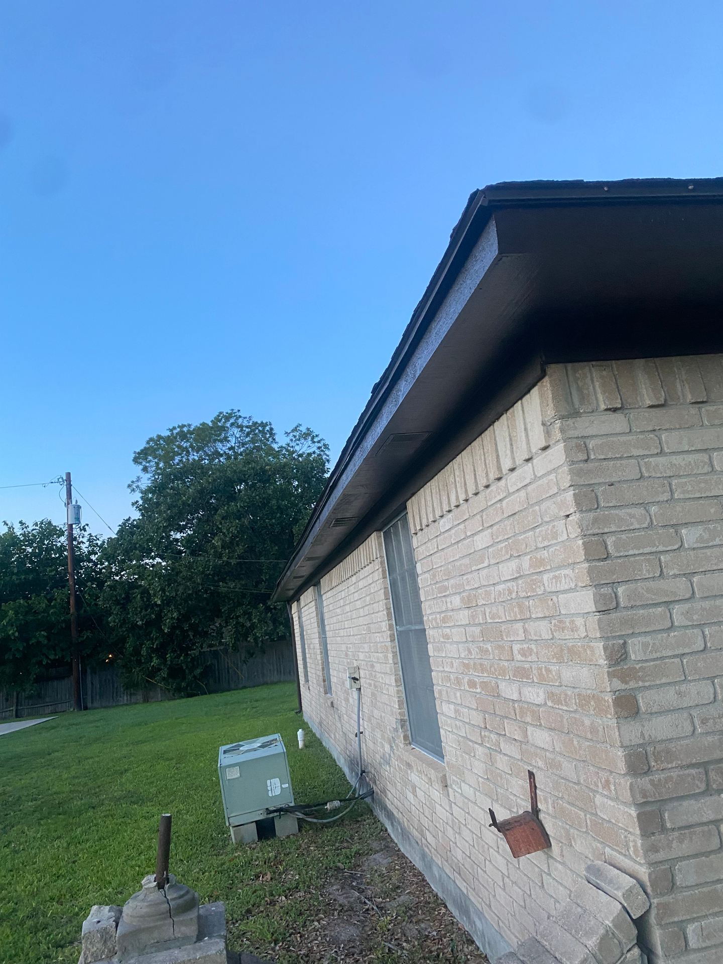Brown painted fascia and soffit on a brick home in South Texas