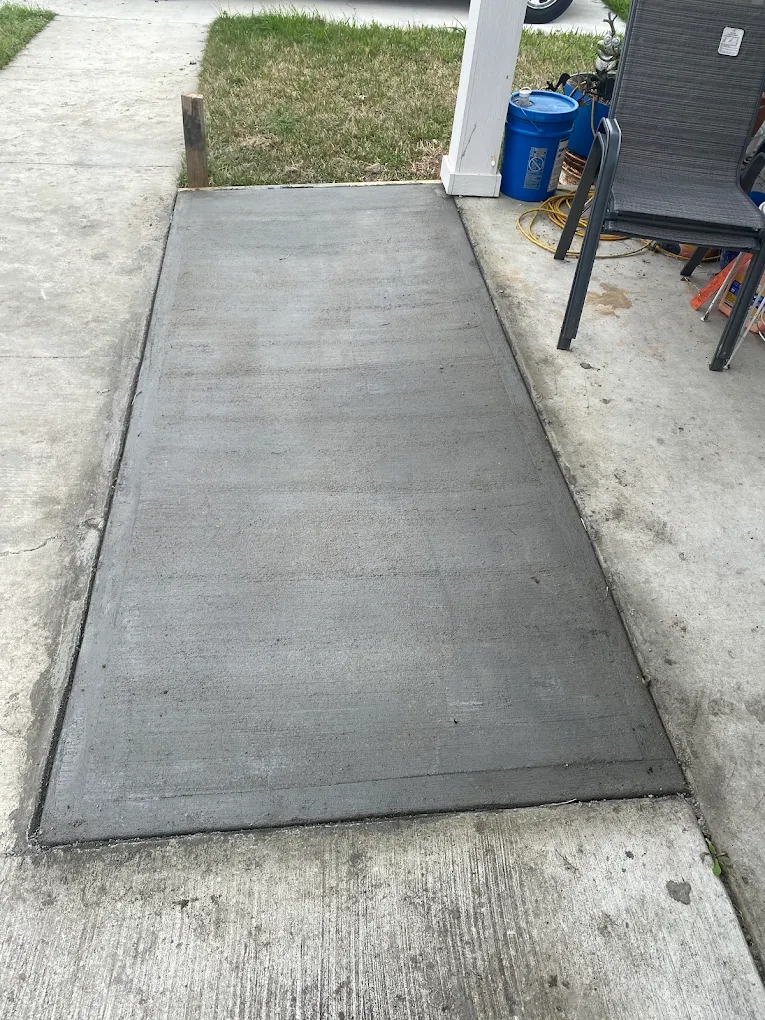New concrete slab extension poured next to an existing patio