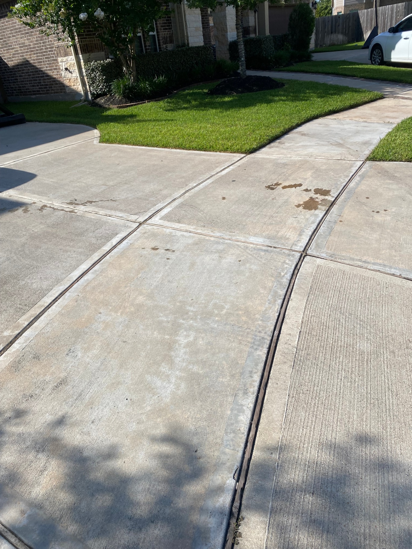 Concrete driveway with clean saw cuts and expansion joints at a residential home