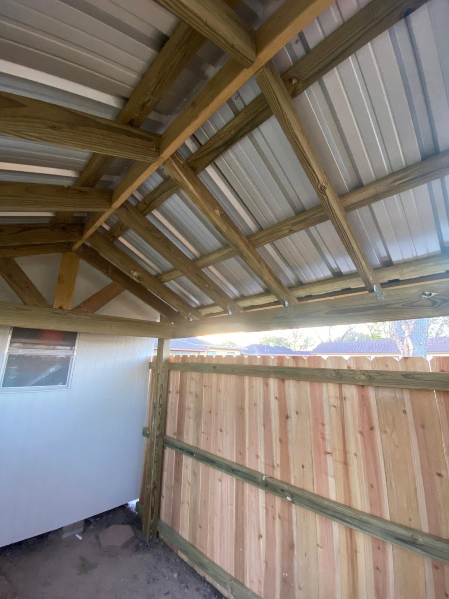 Interior view of cedar shed framing and metal roof decking