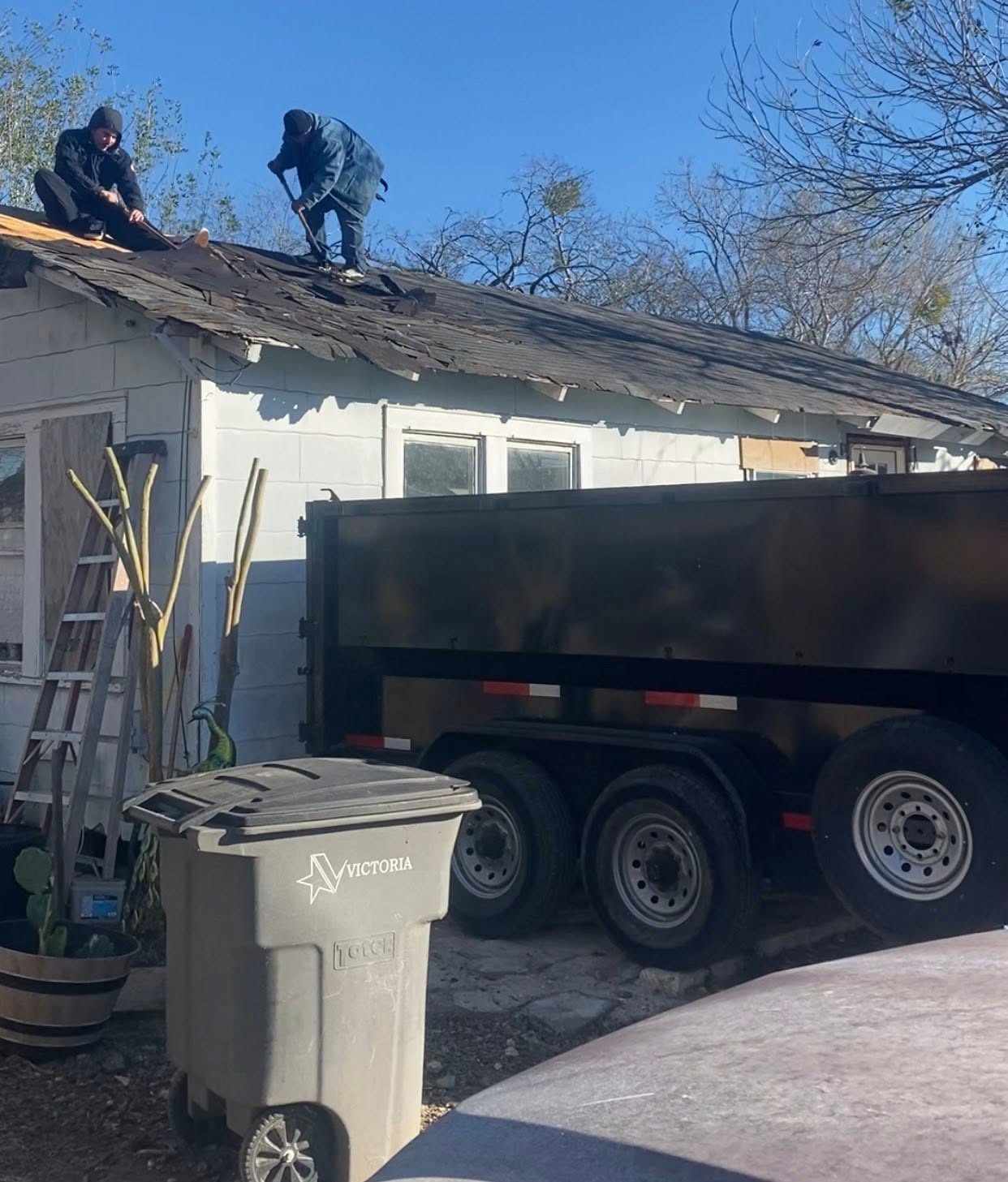 Old School Construction crew tearing off an old shingle roof