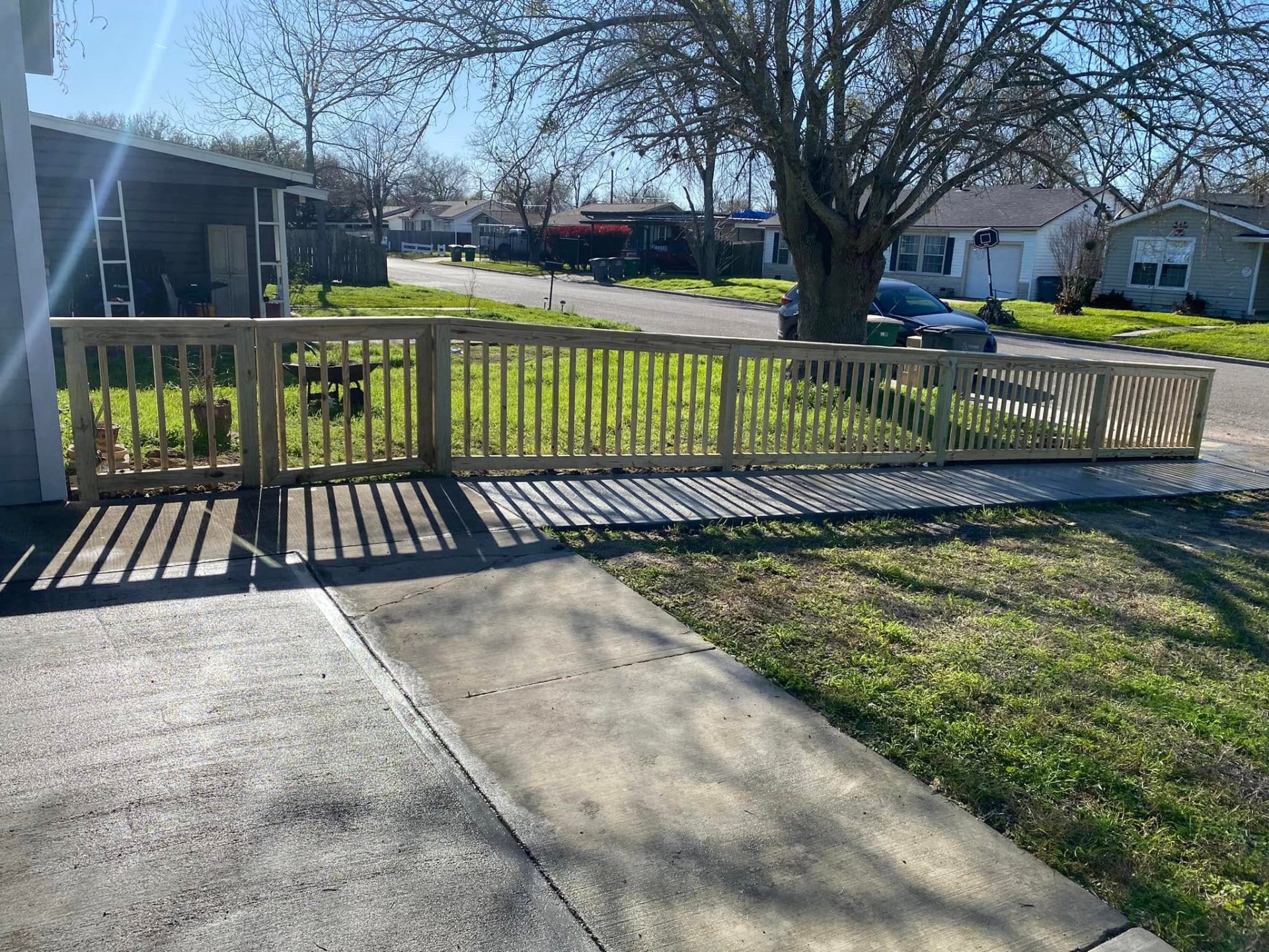 Wood picket fence with corner return at a residential driveway