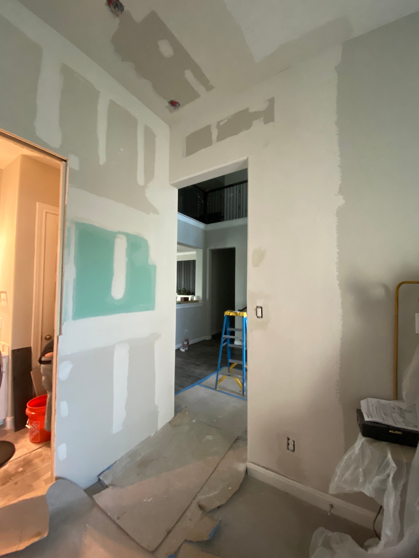 Interior remodel in progress with fresh drywall and joint compound ready for paint